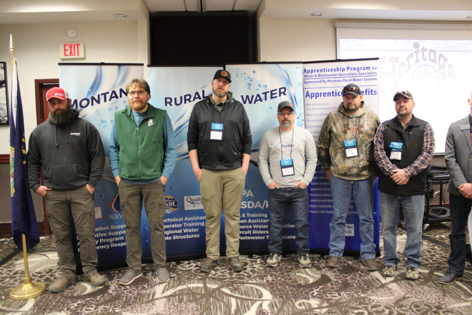 Apprenticeship program participants standing in front of the Montana Rural Water banner